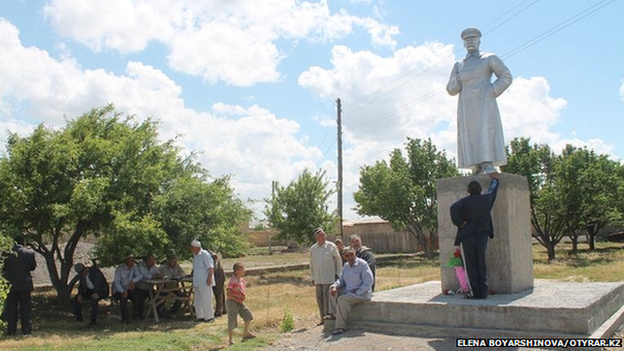 Villagers gathering around the Stalin statue