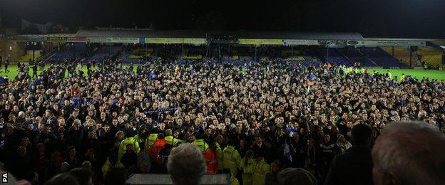 Southend fans flooded onto the Roots Hall pitch in celebration following the final whistle