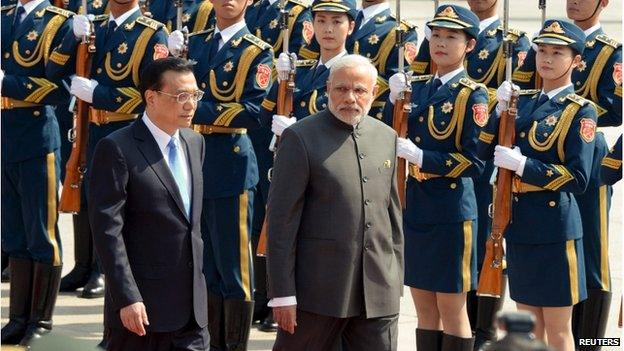 Indian Prime Minister Narendra Modi (R) and Chinese Premier Li Keqiang (L) review an honour guard during a welcome ceremony outside the Great Hall of the People in Beijing, China on 15 May 2015