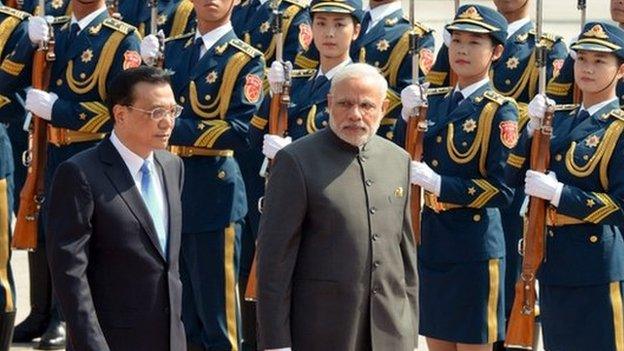 Indian Prime Minister Narendra Modi (R) and Chinese Premier Li Keqiang (L) review an honour guard during a welcome ceremony outside the Great Hall of the People in Beijing, China on 15 May 2015