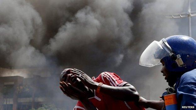 A detained protester cries in front of a burning barricade during a protest against President Pierre Nkurunziza"s decision to run for a third term in Bujumbura, Burundi on 13 May 2015.