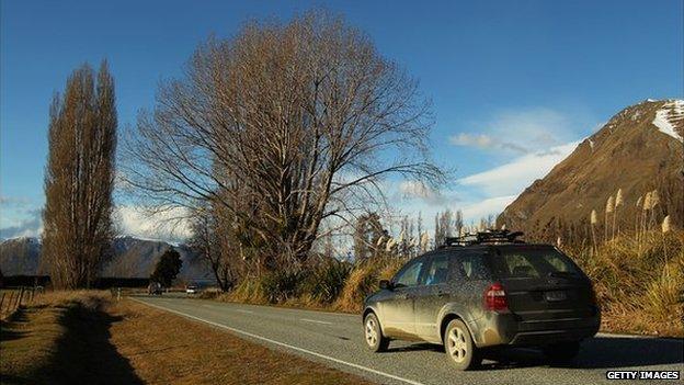 A car driving along a road in New Zealand