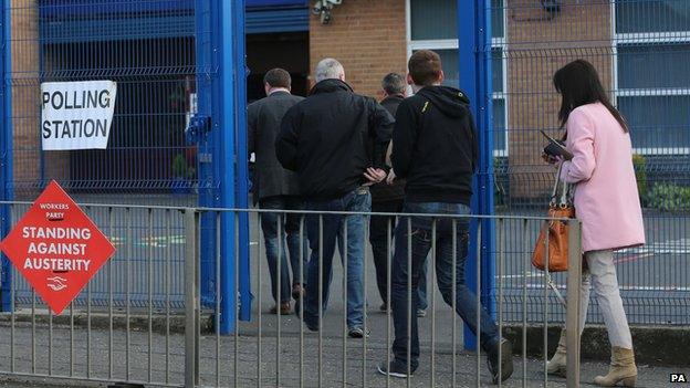 People arrive to vote at St Teresa's Primary School in Belfast on 7 May