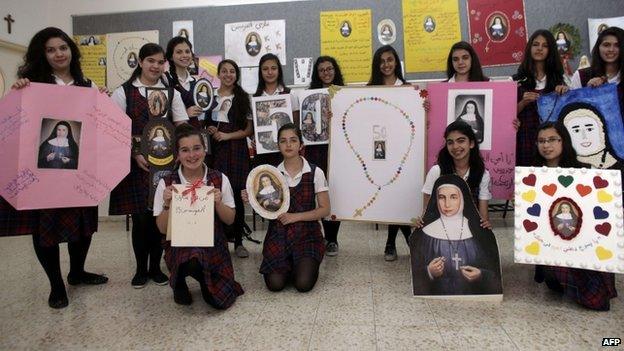 Students of the Rosary Sisters girls" secondary school in Jerusalem"s northern neighborhood of Beit Hanina pose with portraits of Sister Marie Alphonsine Ghattas, on May 12, 2015