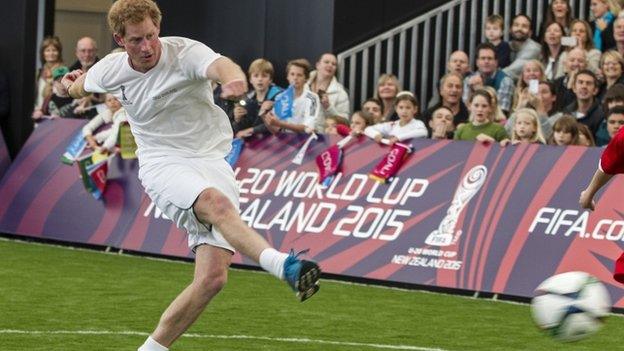 Prince Harry kicking a football