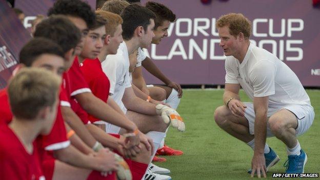 Prince Harry talking to teammates during a five-a-side football match