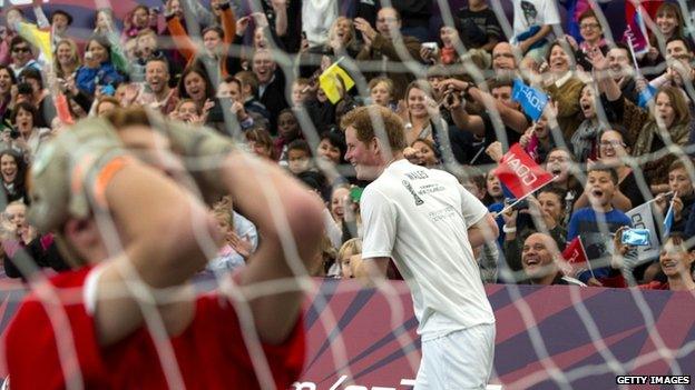 Prince Harry celebrates scoring the winning goal