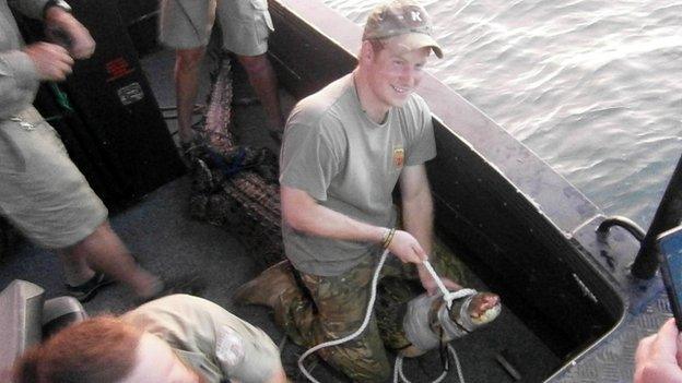 Prince Harry in Australia's Northern Territory sitting on a 3.1 metre crocodile in Darwin Harbour