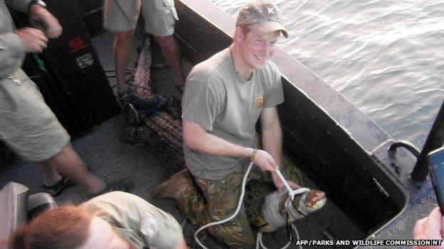 Prince Harry in Australia's Northern Territory sitting on a 3.1 metre crocodile in Darwin Harbour