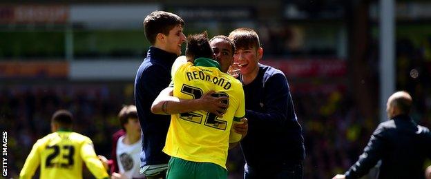 Nathan Redmond and Elliott Bennett celebrate with Norwich fans after the final whistle