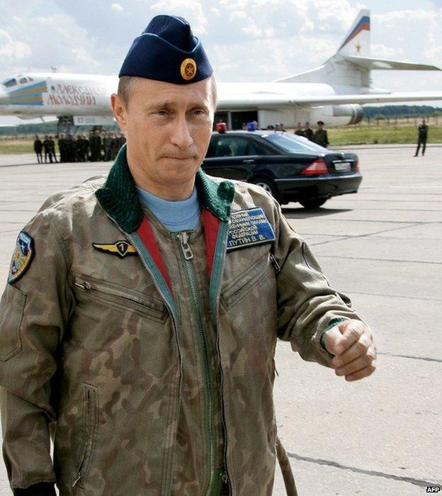 Russian President Vladimir Putin walks near the Tupolev-160 strategic bomber at Moscow's Chkalovsky military airport, 16 August 2005