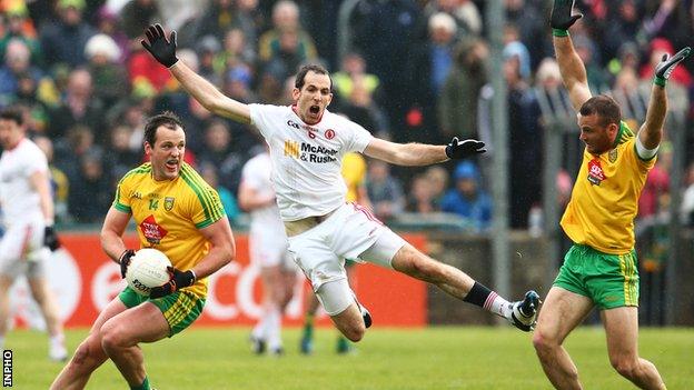 Donegal captain Michael Murphy comes under pressure from Justin McMahon