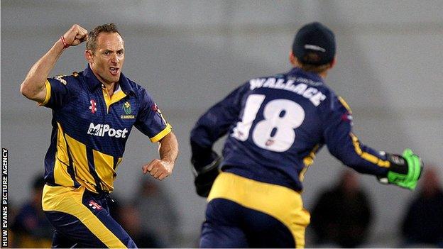 Dean Cosker celebrates taking a wicket against Surrey