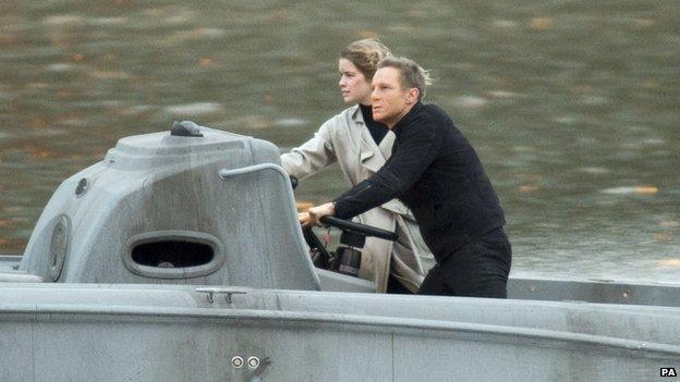 A Daniel Craig stunt double performs in a scene from the new James Bond film on the river Thames near Vauxhall,