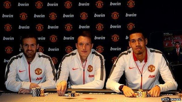 Juan Mata, Phil Jones, and Chris Smalling of Manchester United attend the launch of the Manchester United Bwin Casino App