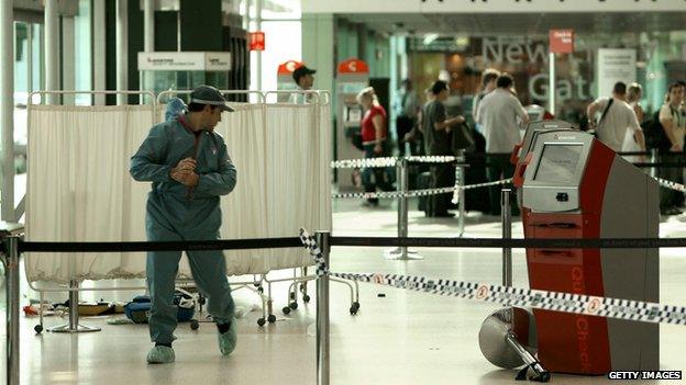 A member of the Australian police forensic personnel at the crime scene at Sydney airport's Terminal on June 29, 2009