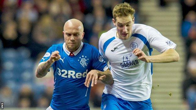 Kevin Holt (right) battles with Rangers' Nicky Law during Queen of the South's 1-1 draw at Ibrox on Sunday