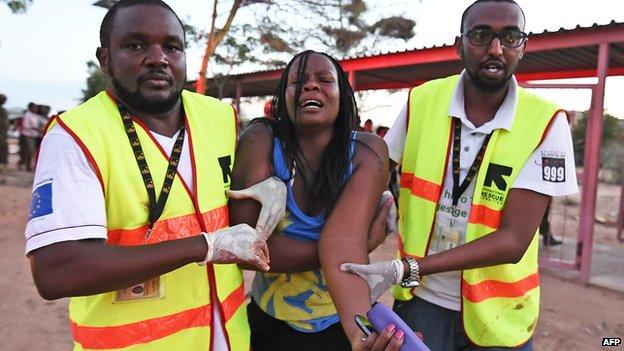 Paramedics help a student who was injured during an attack