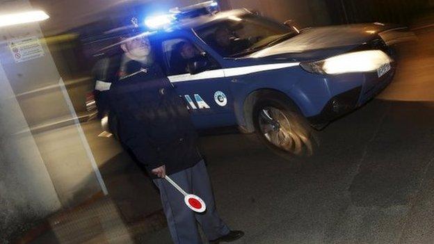 An Italian police car leaves a police station in Pianopoli village, near Catanzaro, Italy on 7 May 2015.