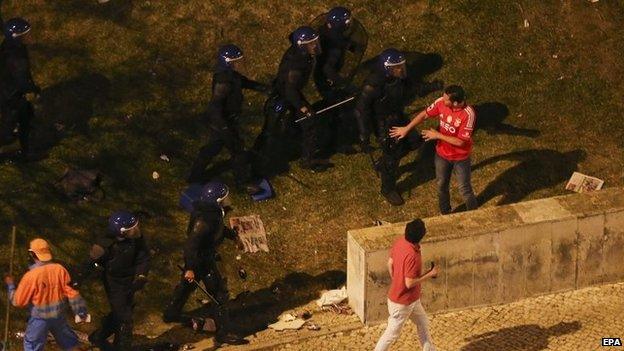 Benfica soccer fans clash with police during celebrations at the Marques de Pombal Square in Lisbon, Portugal on 17 May 2015.