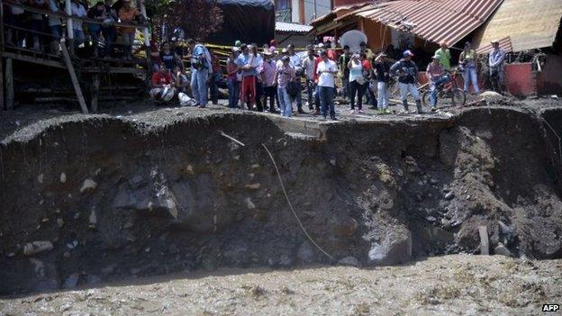 People gather by the banks of a river in Salgar on 18 May 2015