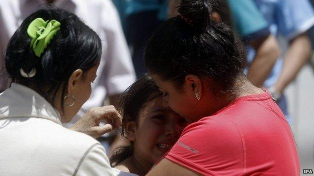 Relatives wait for news on landslide victims in the Salgar on 18 May 2015.