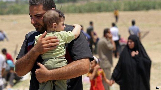 Displaced Iraqis from Ramadi cross the Bzebiz bridge after spending the night walking towards Baghdad, as they flee their hometown of Ramadi on 16 May 2015.