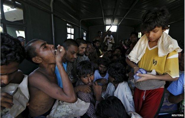 Migrants who arrived by boat sit inside a military truck as they are transported to an immigration office at the port of Julok village in Kuta Binje, Indonesia's Aceh Province, 20 May 2015