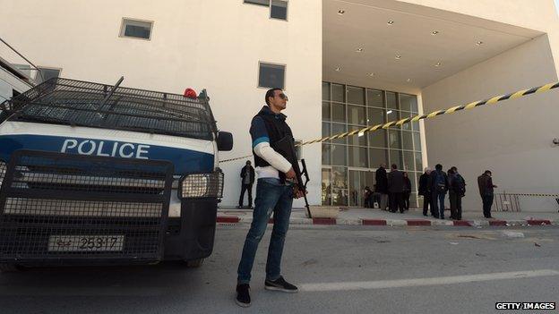 Tunisian security forces and forensic experts stand at the visitors entrance of the National Bardo Museum in Tunis