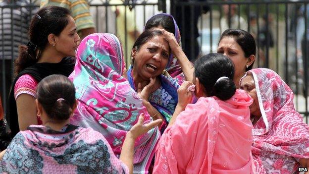 Relatives of victims who were killed when unknown assailants opened fire at a bus that was carrying members of Ismaili Shia community