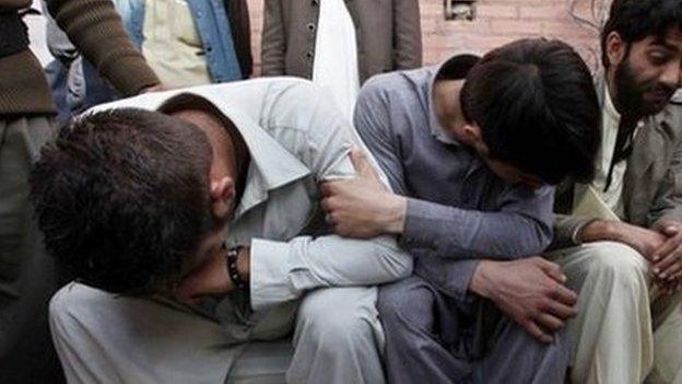 Unidentified relatives of the victims of the suicide bomb attack on a Shiite Mosque, react to the deaths of their loved ones, at a local hospital in Peshawar, Pakistan, 13 February 2015