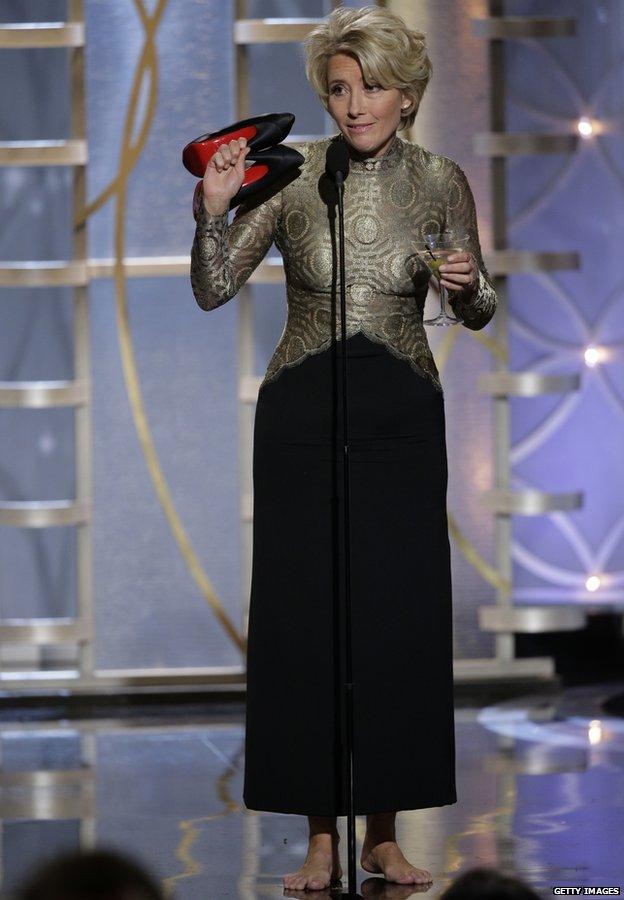 Emma Thompson holds her shoes at the Golden Globes 12 January 2014