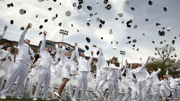 Graduates toss their caps in the air at the closing of the 134th Commencement Exercises of the United States Coast Guard Academy in New London, Connecticut 20 May 2015