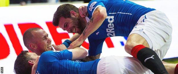 Nicky Clark (bottom) celebrates his goal with Rangers team-mates Kenny Miller (centre) and Richard Foster