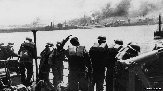 British troops pictured looking back at the French coast from the deck of a steamer taking them back to England in June 1940