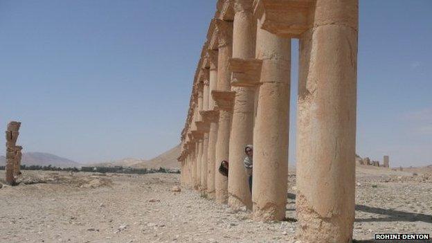 Women peeking out amidst ruins