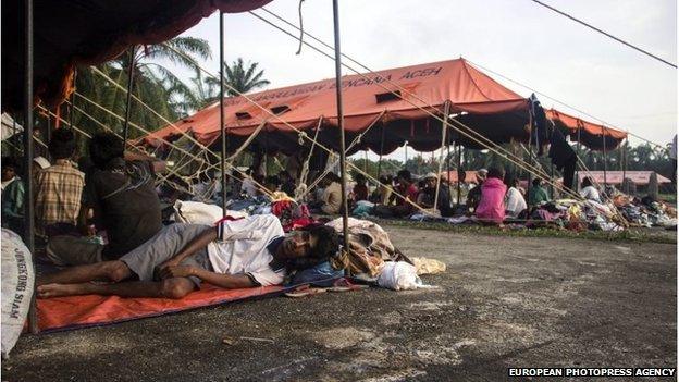 A Rohingya refugee takes a rest after being saved from the sea, at a temporary shelter in Bayeun village, East Aceh, Indonesia, 21 May 2015.