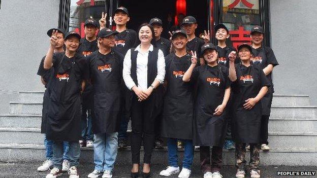 Hu Yanping and her staff outside the Forrest Gump restaurant