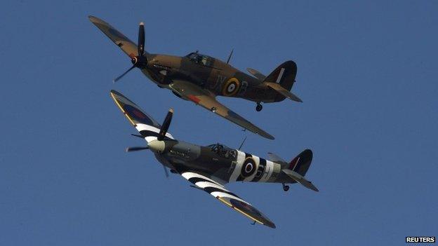 Hurricane and Spitfire planes perform a fly-past