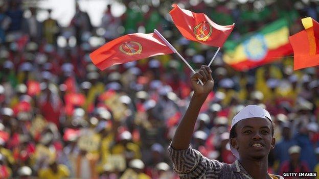 A youth waves the ruling party Ethiopian Peoples Revolutionary Democratic Front (EPRDF) flag in front of a large crowd during an election rally by the EPRDF