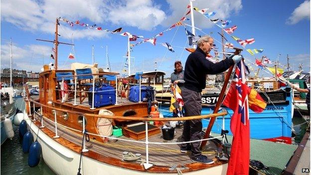 Sailors prepare their boats ahead of their journey across the English Channel