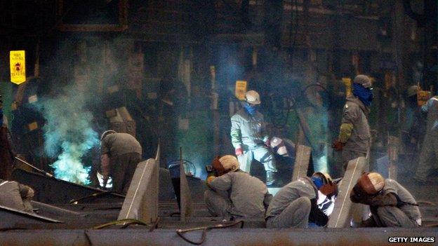 Welders working on a ship at South Korea's Ulsan shipyard