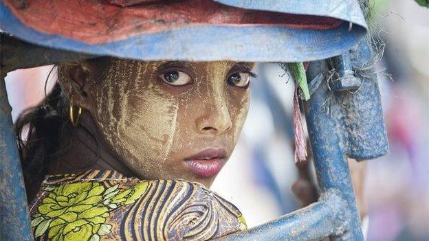 This photo taken on May 21, 2015 shows an ethnic Rohingya Muslim woman looking back as she rides a tuk tuk near a camp set up outside the city of Sittwe in Myanmar's Rakhine state.