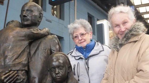 Milena Grenfell-Baines (left) and Ruth Halova next to the statue which commemorates Winton's efforts at Prague railway station