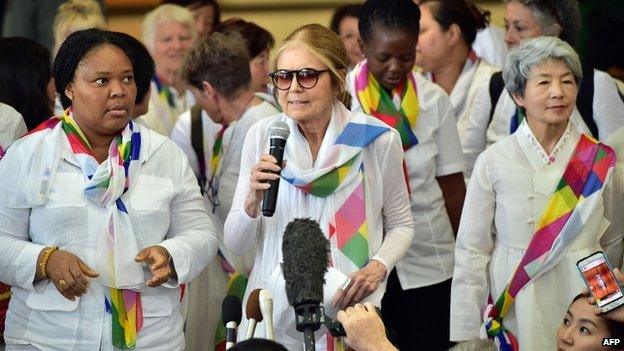 US feminist Gloria Steinem (C) speaks to the media as her group of peace activists arrives at the inter-Korea transit office after they crossed the border line through the demilitarised zone (DMZ) separating the two Koreas in Paju on 24 May 2015.