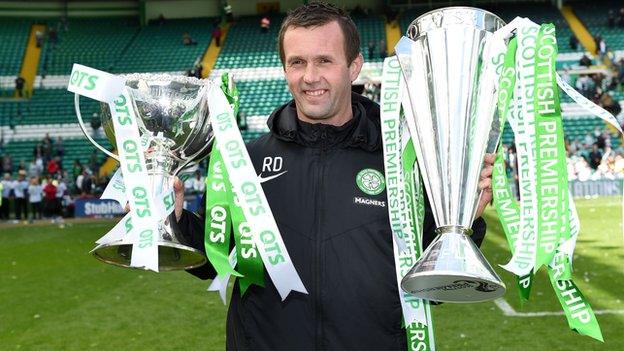 Celtic manager Ronny Deila holds the Scottish Premiership and Scottish League Cup trophies