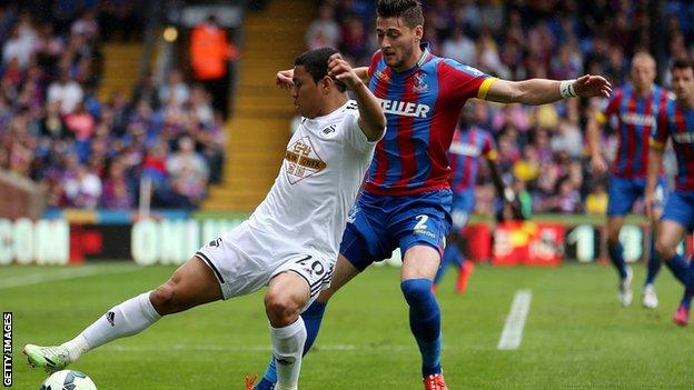 Swansea's Jefferson Montero is challenged by Joel Ward of Crystal Palace.