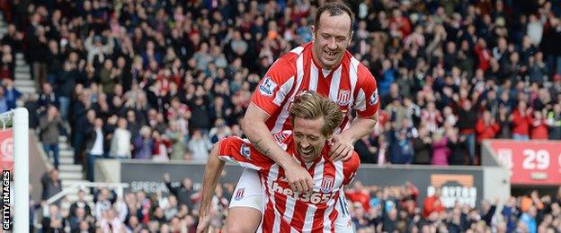 Stoke's ex-Liverpool striker Peter Crouch celebrates scoring his side's sixth goal former Reds midfielder Charlie Adam