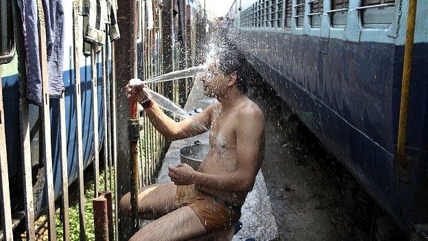 Train passenger cools off at railway station in Jammu. 25 May 2015