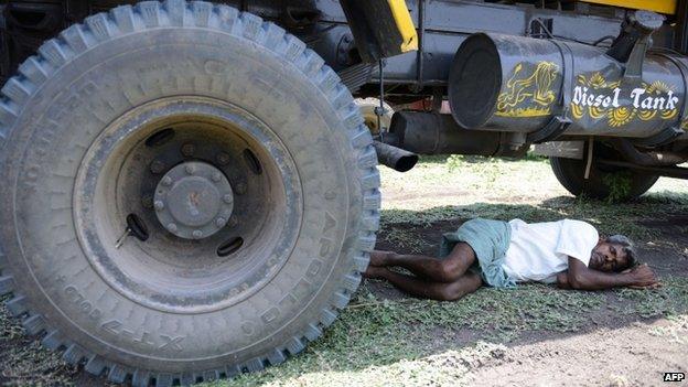 Indian shelters under transport vehicle in Hyderabad